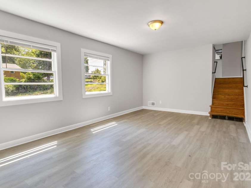 4635 Thornwood Road, Charlotte, NC 28213.  MLS# CAR4276510, YatesRealty ID 30250. Second shot of lower-level bonus room. Stairs on right of photo lead back to main level (where living room, kitchen & dining area are).