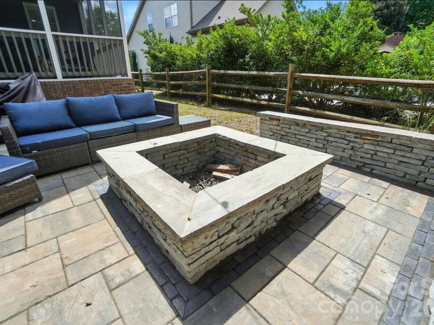 342 Shoreline Parkway, Tega Cay, SC 29708.  MLS# CAR4380050, YatesRealty ID 30261. Professionally designed by Howell Designs, the impressive hardscape features inviting gathering spaces centered around a cozy fire pit, making outdoor living enjoyable year-round.