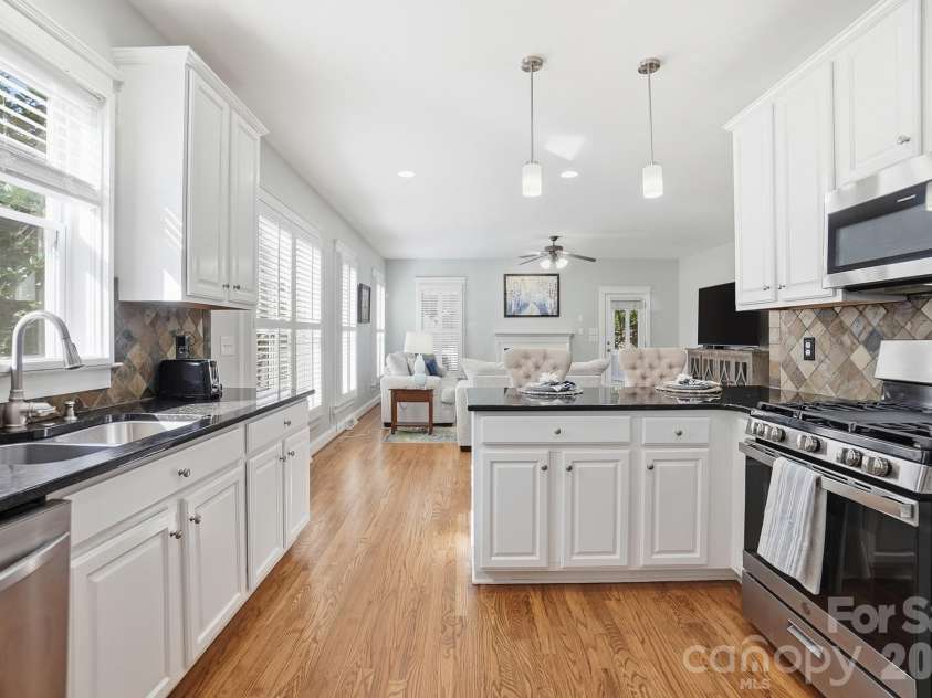 342 Shoreline Parkway, Tega Cay, SC 29708.  MLS# CAR4380050, YatesRealty ID 30261. The kitchen features crisp white cabinetry and elegant granite counters for a fresh, modern feel.