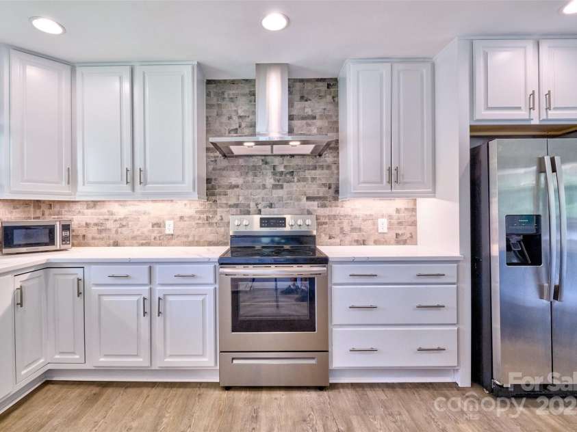 7753 Caswell Road, Stanley, NC 28164.  MLS# CAR4276529, YatesRealty ID 30264. Backslash, hood, and new appliances