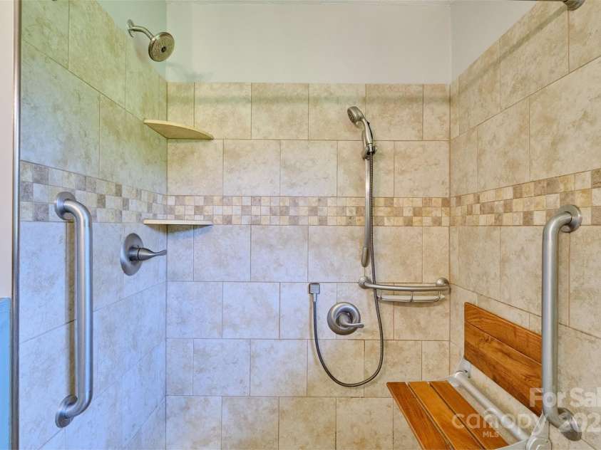 7753 Caswell Road, Stanley, NC 28164.  MLS# CAR4276529, YatesRealty ID 30264. Bathroom with grab bars and shower seat