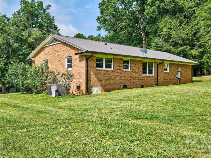 7753 Caswell Road, Stanley, NC 28164.  MLS# CAR4276529, YatesRealty ID 30264. Rear view of home