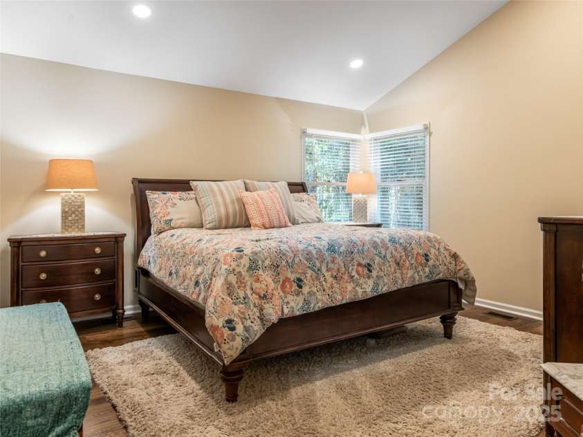 206 Pinner Road, Arden, NC 28704.  MLS# CAR4276364, YatesRealty ID 30266. Large primary bedroom with sloped ceiling, en suite bath and custom finished walk in closet.