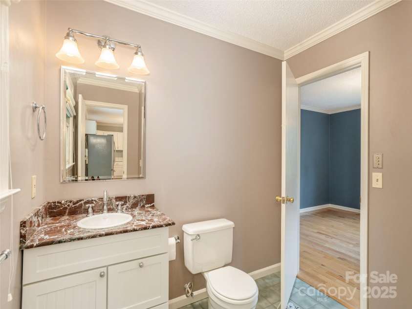 55 Willow Bend, Hendersonville, NC 28792.  MLS# CAR4255625, YatesRealty ID 30273. Main floor full bathroom with marble vanity top, walk in shower and tiled floor.