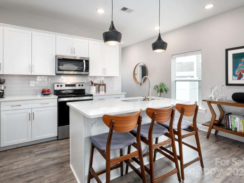 58 Walnut Springs Drive, Asheville, NC 28804.  MLS# CAR4259966, YatesRealty ID 30297. Kitchen island with upgraded lighting and quartz counters