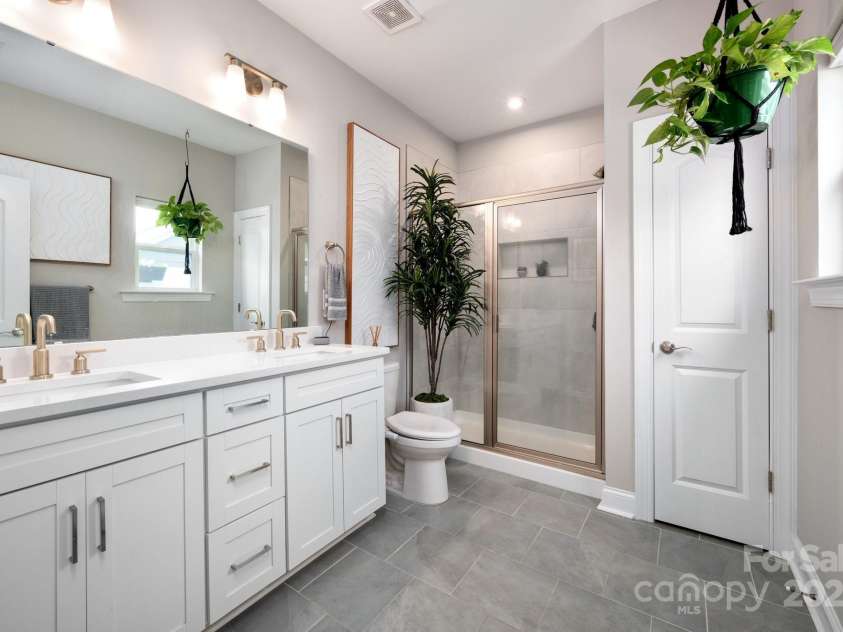 58 Walnut Springs Drive, Asheville, NC 28804.  MLS# CAR4259966, YatesRealty ID 30297. Stunning primary bath with dual sink and walk in shower and toilet room