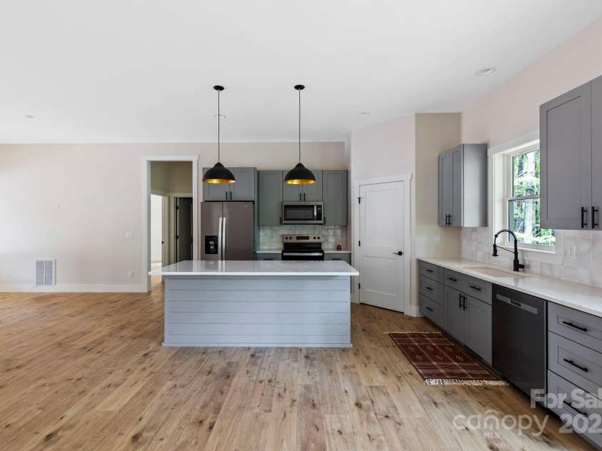 939 Rocky Mountain Road, Lake Toxaway, NC 28747.  MLS# CAR4279855, YatesRealty ID 30318. Kitchen with dining table space big enough 6-8 person table