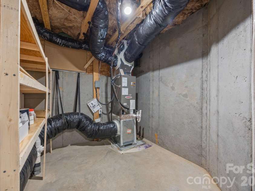 15012 Courtside Cove Lane, Cornelius, NC 28031.  MLS# CAR4326155, YatesRealty ID 30321. HVAC and storage space in basement