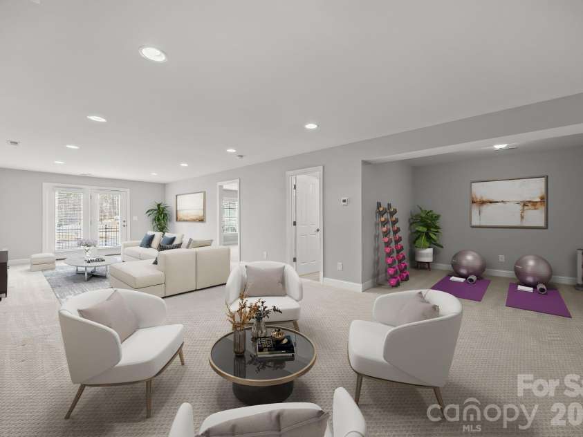 15012 Courtside Cove Lane, Cornelius, NC 28031.  MLS# CAR4326155, YatesRealty ID 30321. Virtually staged large den in finished basement