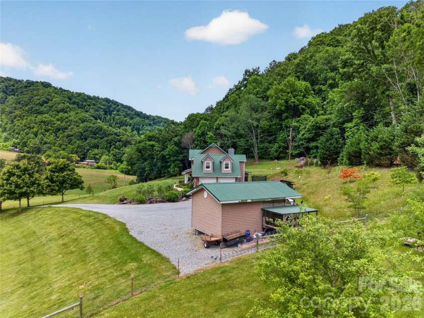 227 Black Bear Cove, Clyde, NC 28721.  MLS# CAR4393191, YatesRealty ID 30326. Aerial with workshop/farm equipment storage