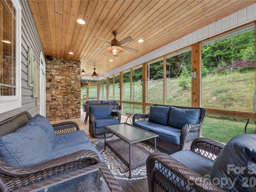 227 Black Bear Cove, Clyde, NC 28721.  MLS# CAR4393191, YatesRealty ID 30326. Back covered & Screen porch with fireplace