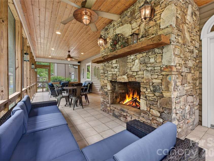 227 Black Bear Cove, Clyde, NC 28721.  MLS# CAR4393191, YatesRealty ID 30326. Screened covered back porch with fireplace