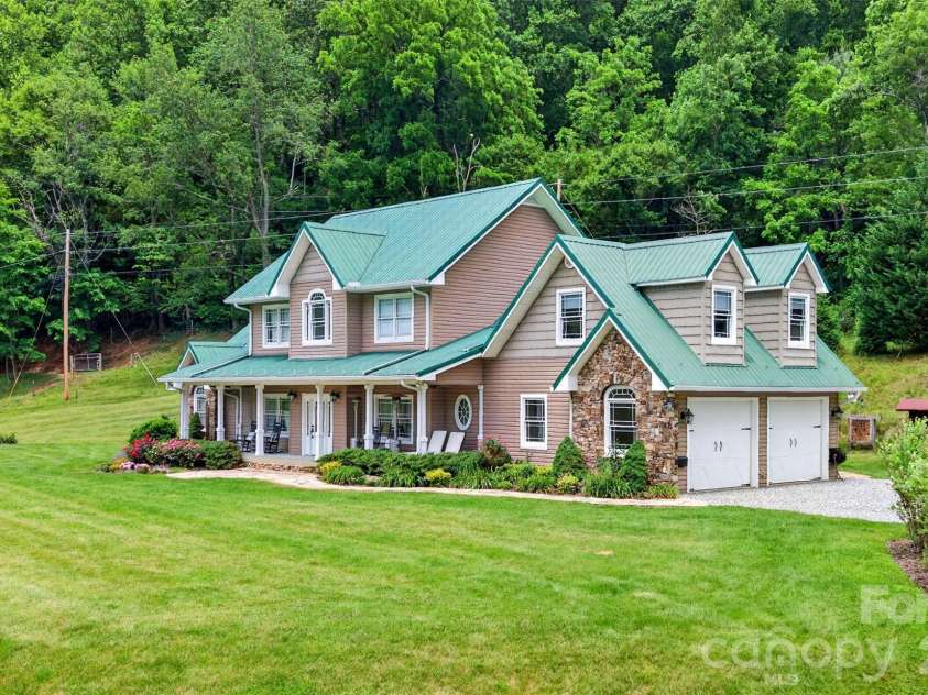 227 Black Bear Cove, Clyde, NC 28721.  MLS# CAR4393191, YatesRealty ID 30326. Side view with garage