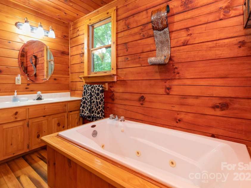 192 Granny Shepherd Road, Mars Hill, NC 28754.  MLS# CAR4285512, YatesRealty ID 3033. Main level bathroom en suite with jetted tub.