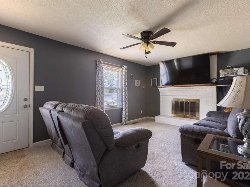 120 Lafayette Road, Stanley, NC 28164.  MLS# CAR4279508, YatesRealty ID 30357. Enter the Living room from the front door. Beautiful brick fireplace.