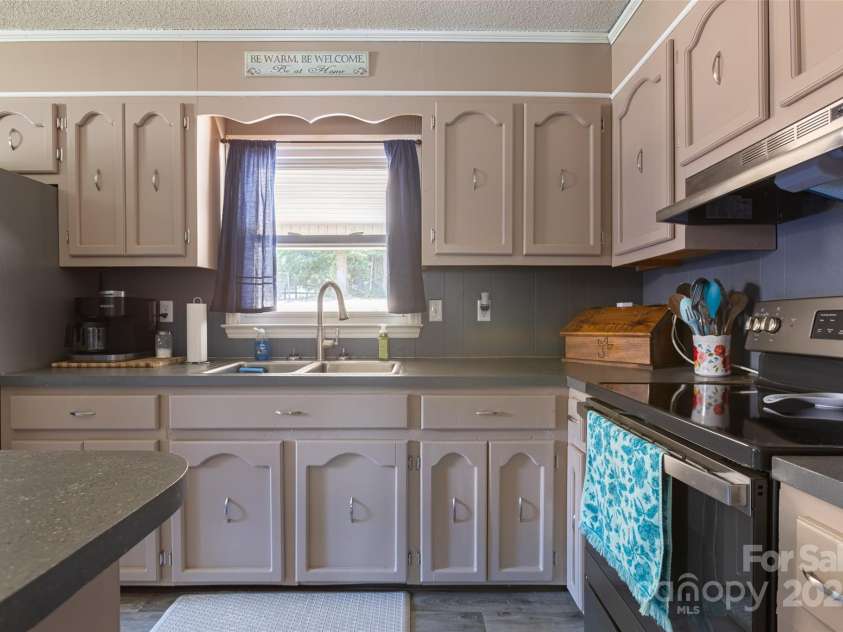 120 Lafayette Road, Stanley, NC 28164.  MLS# CAR4279508, YatesRealty ID 30357. Kitchen features SS appliances and kitchen Island.