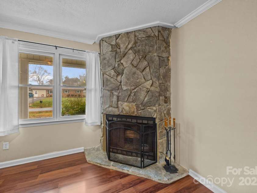 1158 Sunset Court, Conover, NC 28613.  MLS# CAR4328975, YatesRealty ID 3036. Living Room w/ Woodburning Fireplace