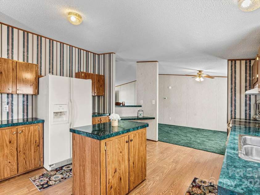 2800 Brushwood Circle, Newton, NC 28658.  MLS# CAR4288280, YatesRealty ID 30364. Open Concept Kitchen Island/Dining Area View (New Laminate Flooring)
