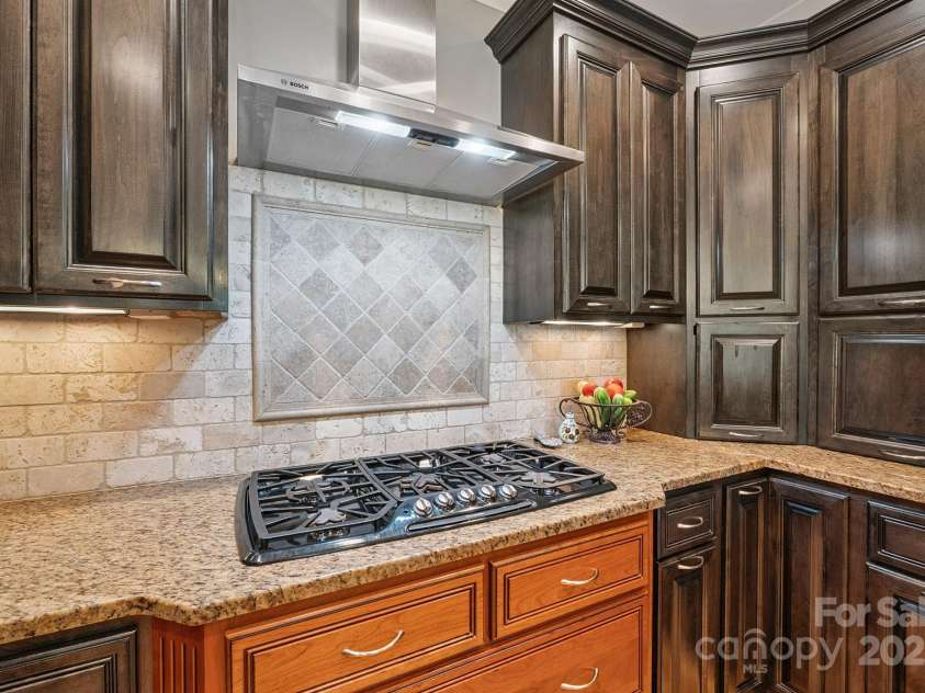 8304 Renee Ford Road, Stanfield, NC 28163.  MLS# CAR4281370, YatesRealty ID 30368. 5 burner gas stove and walls of cabinets.