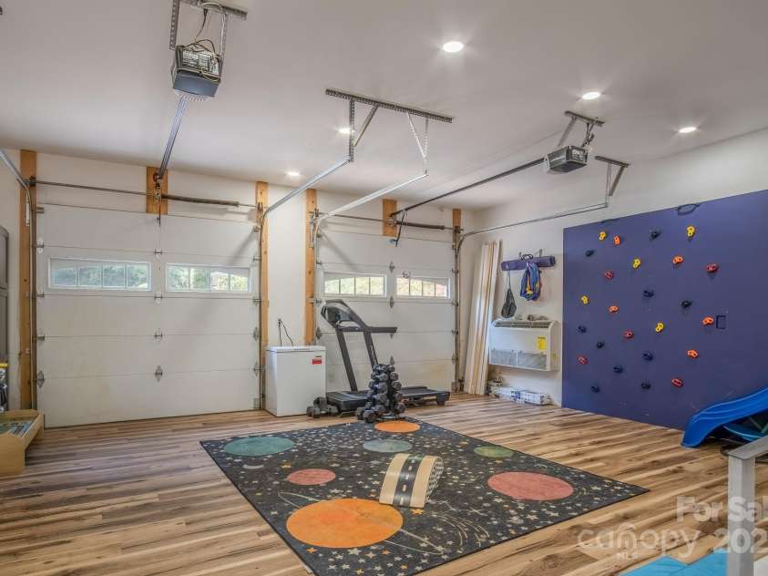 50 Red Clover Lane, Pisgah Forest, NC 28768.  MLS# CAR4271803, YatesRealty ID 30371. 2 car garage on main level used as play room