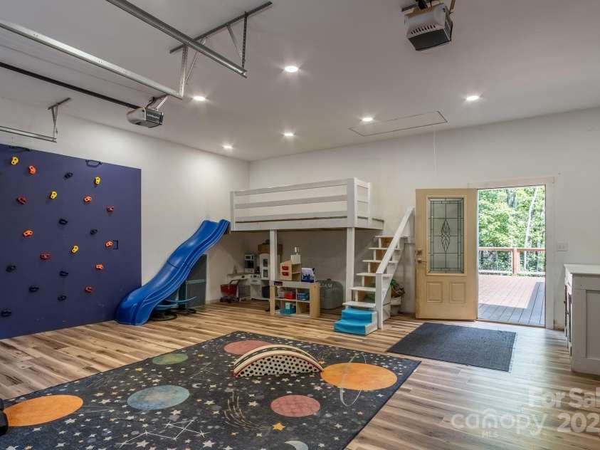 50 Red Clover Lane, Pisgah Forest, NC 28768.  MLS# CAR4271803, YatesRealty ID 30371. 2 car garage on main level used as play room with separate HVAC