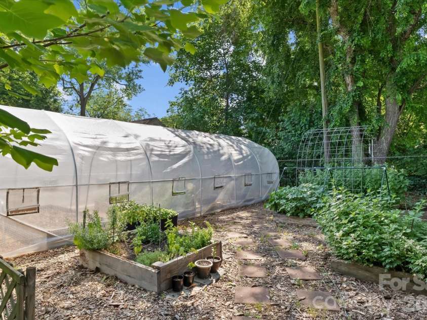 354 Bost Street, Statesville, NC 28677.  MLS# CAR4344460, YatesRealty ID 30407. Greenhouse with several raised beds.