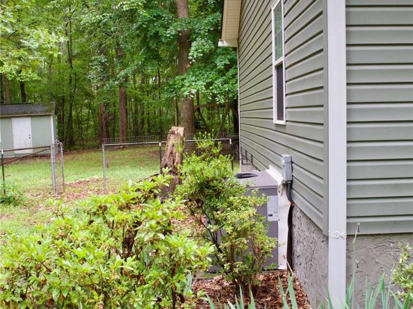 908 Buddys Choice Road, York, SC 29745.  MLS# CAR4381686, YatesRealty ID 30413. Left side of home, view to back yard