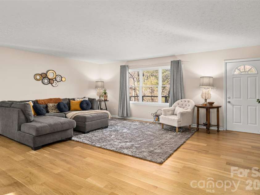 73 The Old Run Road, Fairview, NC 28730.  MLS# CAR4329903, YatesRealty ID 30415. Great Room with solid white oak flooring