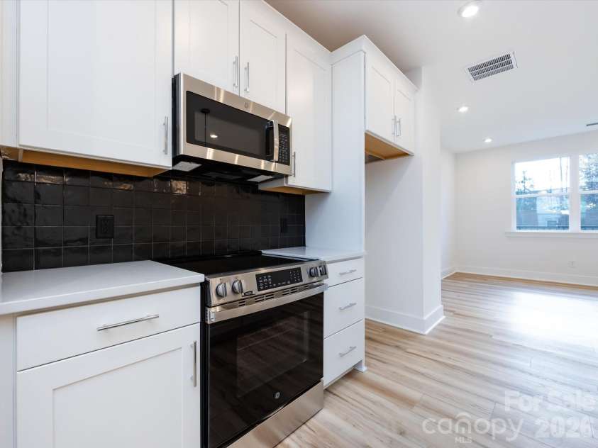 7022 Impulse Court, Charlotte, NC 28205.  MLS# CAR4349977, YatesRealty ID 30446. Kitchen featuring bold black backsplash