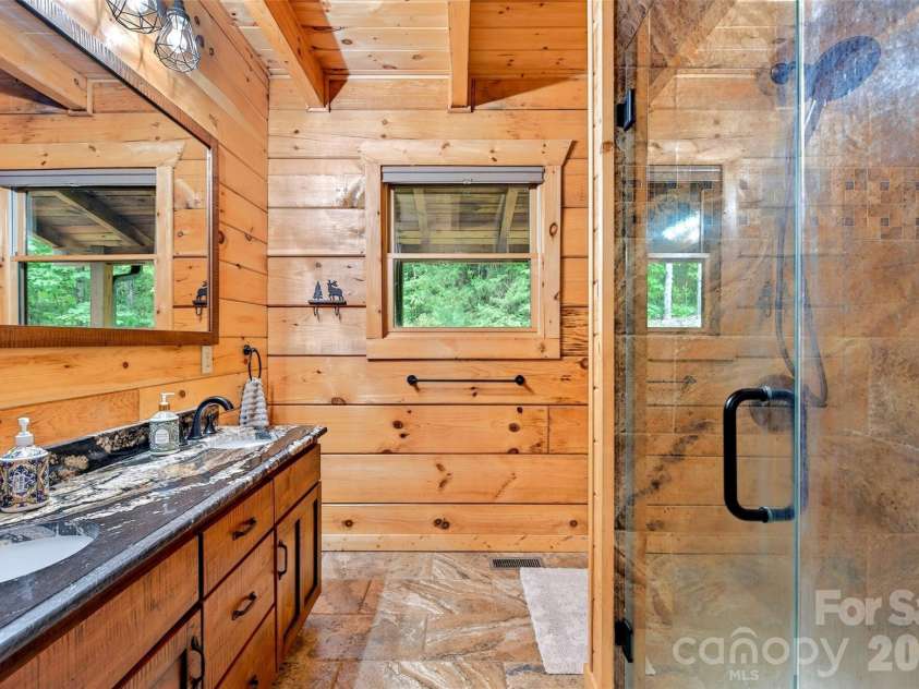 34 Waterfall Drive, Marion, NC 28752.  MLS# CAR4381910, YatesRealty ID 30452. Primary bathroom with double vanity and walk in shower