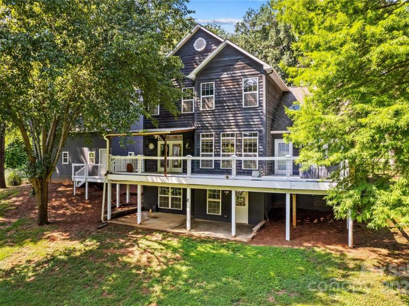 315 Wood Duck Loop, Mooresville, NC 28117.  MLS# CAR4268002, YatesRealty ID 30458. 315 Wood Duck Loop, Mooresville NC MLS 4268002 Waterfront on Lake Norman. Back of house, 2 story home with walk out basement and fenced yard.