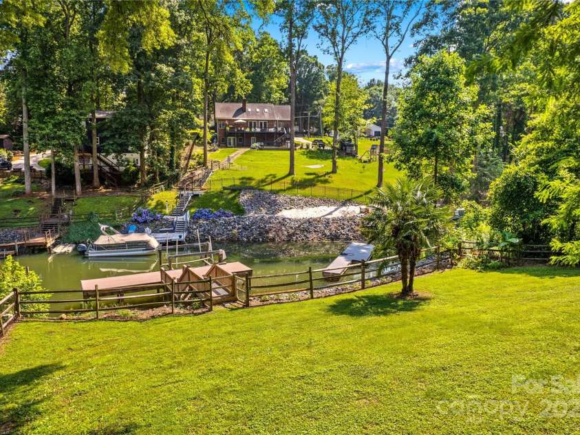 315 Wood Duck Loop, Mooresville, NC 28117.  MLS# CAR4268002, YatesRealty ID 30458. 315 Wood Duck Loop, Mooresville NC MLS 4268002 Waterfront. View from the fenced backyard. Boat lift and dock in the cove on Lake Norman
