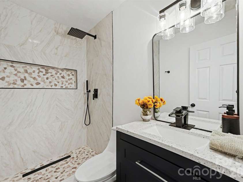 105 3rd Avenue, Hildebran, NC 28637.  MLS# CAR4327231, YatesRealty ID 3046. Hallway Bathroom