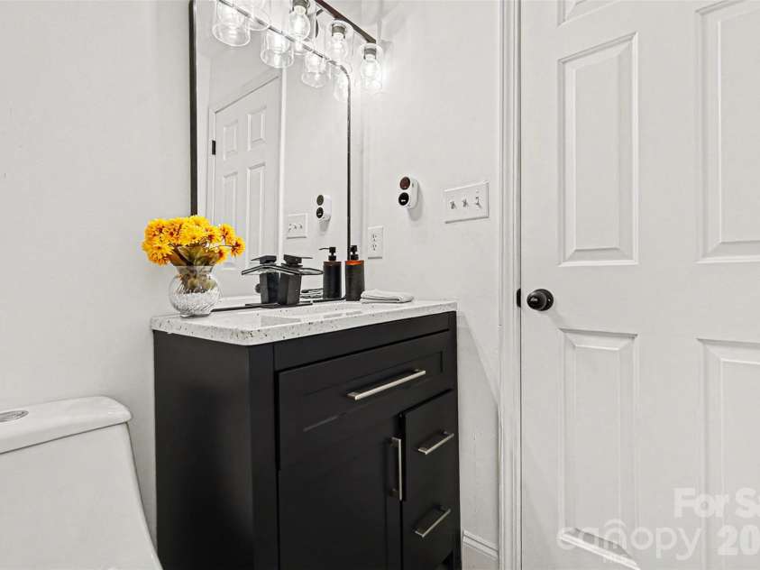 105 3rd Avenue, Hildebran, NC 28637.  MLS# CAR4327231, YatesRealty ID 3046. Hallway Bathroom: Sink
