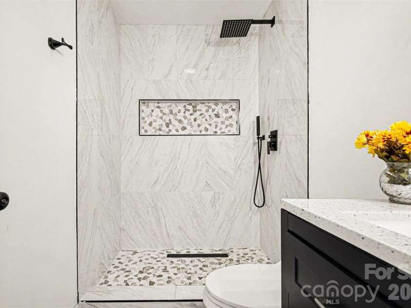 105 3rd Avenue, Hildebran, NC 28637.  MLS# CAR4327231, YatesRealty ID 3046. Hallway Bathroom: Walk-In Shower