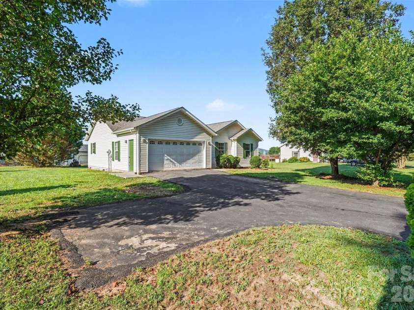 105 3rd Avenue, Hildebran, NC 28637.  MLS# CAR4327231, YatesRealty ID 3046. Side View: 2 ca garage and additional driveway parking spaces
