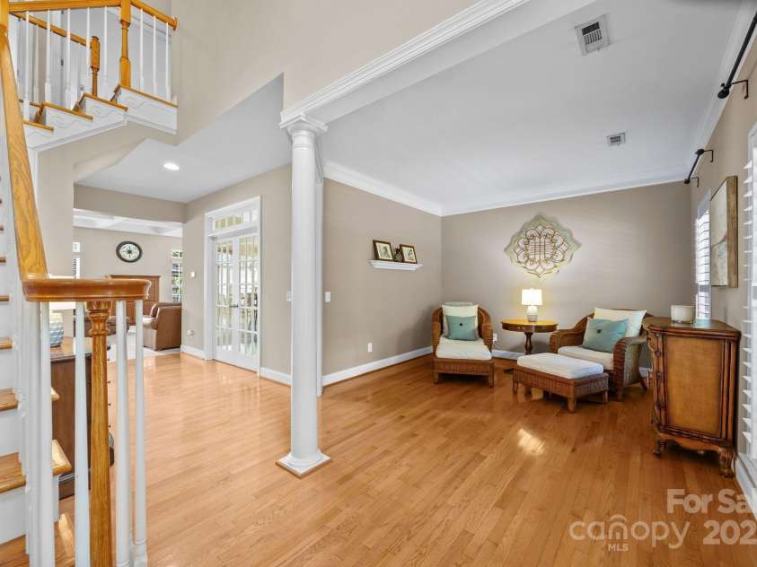 6703 Garden Hill Drive, Huntersville, NC 28078.  MLS# CAR4265776, YatesRealty ID 30476. Living room with plantation shutters and crown molding detail