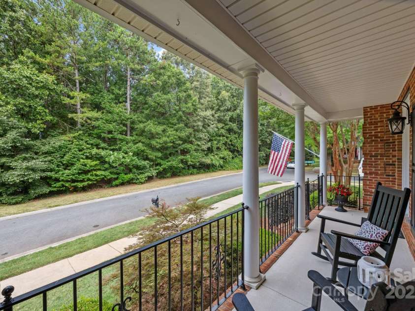 6703 Garden Hill Drive, Huntersville, NC 28078.  MLS# CAR4265776, YatesRealty ID 30476. Rocking chair front porch overlooks community green space