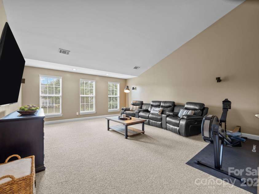6703 Garden Hill Drive, Huntersville, NC 28078.  MLS# CAR4265776, YatesRealty ID 30476. Vaulted bonus room with wall speakers is a great multi-purpose space for a home theater, workout room, 5th bedroom, etc