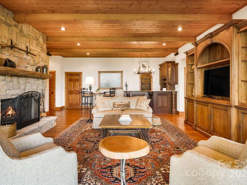 197 Cherry Knob Drive, Mars Hill, NC 28754.  MLS# CAR4271284, YatesRealty ID 30496. Gather by the grand stone fireplace in this cozy yet spacious living room, perfect for entertaining or relaxing with loved ones.