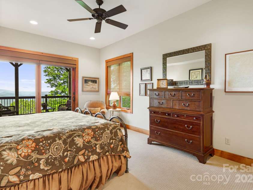 197 Cherry Knob Drive, Mars Hill, NC 28754.  MLS# CAR4271284, YatesRealty ID 30496.  This spacious second primary suite opens directly to a covered deck—perfect for your morning coffee with a view.