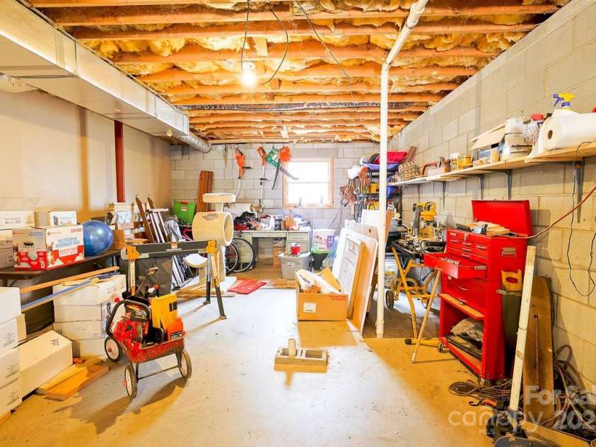 17 Morris Drive, Weaverville, NC 28787.  MLS# CAR4222234, YatesRealty ID 30498. Back of the basement with a window to the back. You could finish off the downstairs for a new living space.