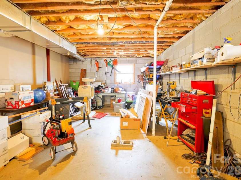17 Morris Drive, Weaverville, NC 28787.  MLS# CAR4333064, YatesRealty ID 30498. Back of the basement with a window to the back. You could finish off the downstairs for a new living space.