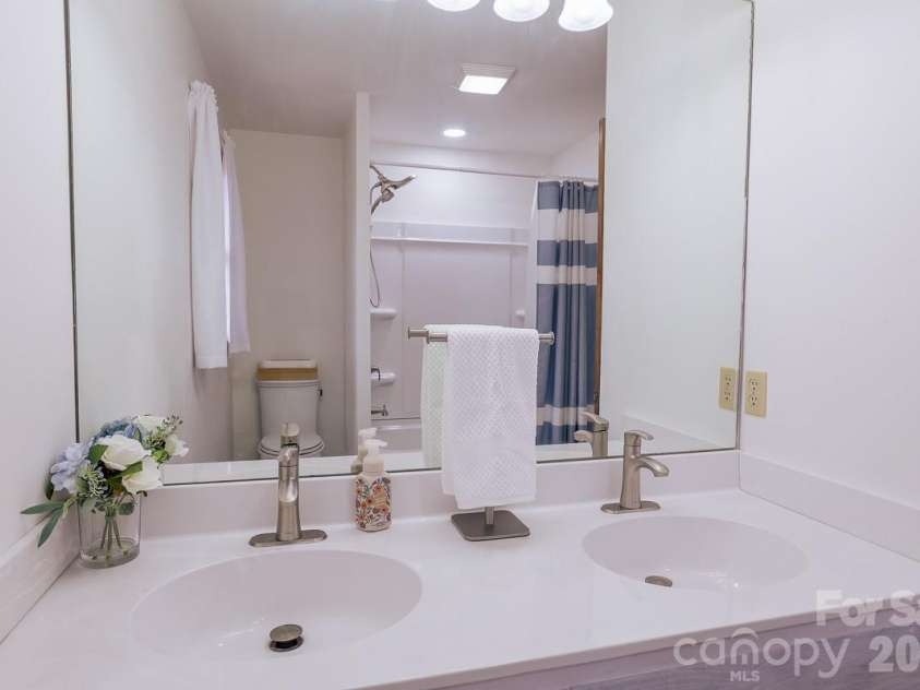 17 Morris Drive, Weaverville, NC 28787.  MLS# CAR4333064, YatesRealty ID 30498. Bathroom upgrade includes a new toilet, freshly painted vanity and walls, new hardware and mirror. Complete with fresh tile floors.