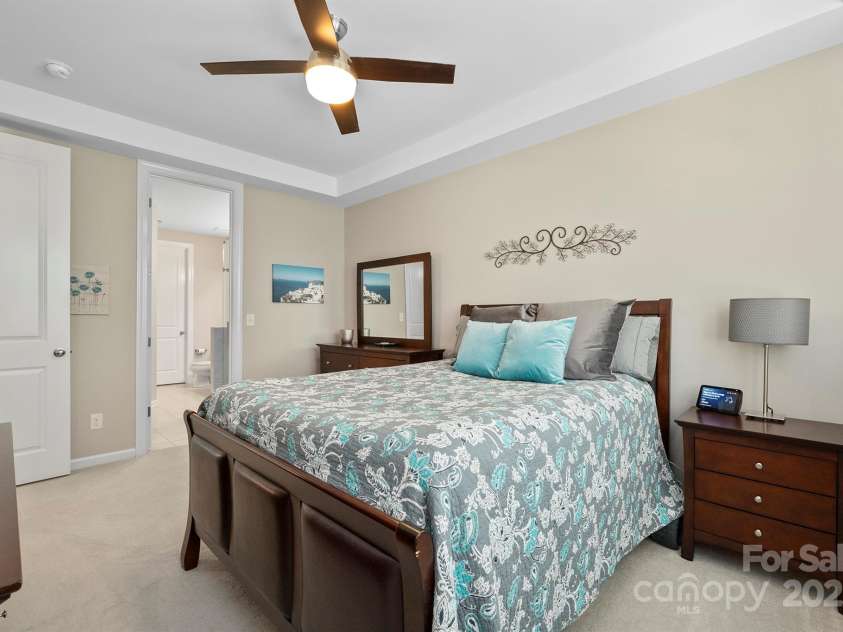 7322 Dulnian Way, Charlotte, NC 28278.  MLS# CAR4272540, YatesRealty ID 30530. Large primary bedroom on main floor with tray ceiling and cooling fan.