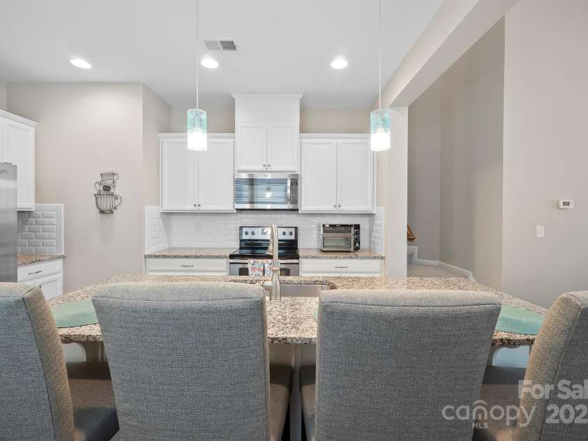 7322 Dulnian Way, Charlotte, NC 28278.  MLS# CAR4272540, YatesRealty ID 30530. Pendant lights above island with seating for 4.