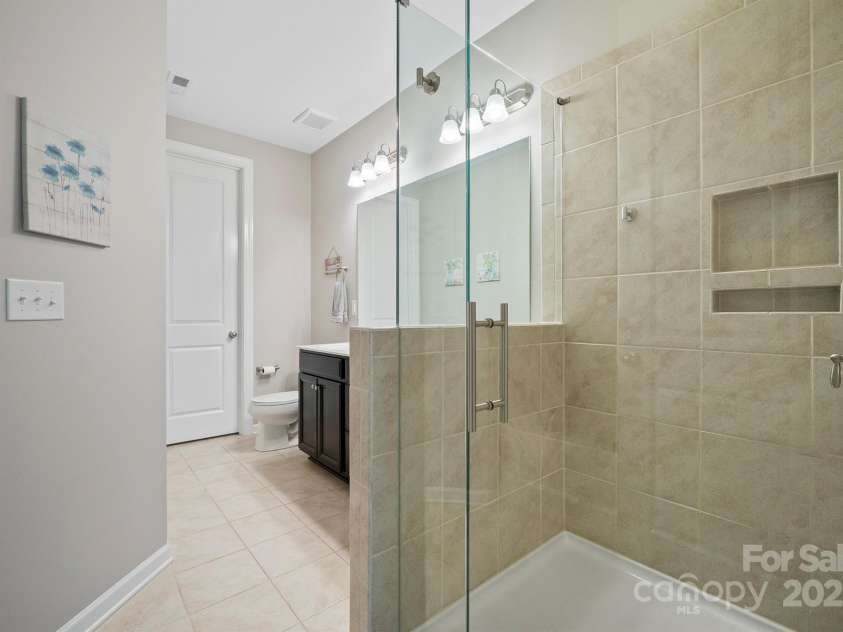 7322 Dulnian Way, Charlotte, NC 28278.  MLS# CAR4272540, YatesRealty ID 30530. Primary bathroom with tiled, frameless shower.