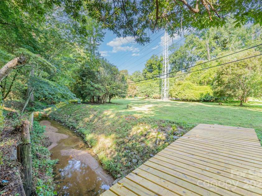 5811 Doncaster Drive, Charlotte, NC 28211.  MLS# CAR4281754, YatesRealty ID 30581. Bridge to other part of the yard & barn