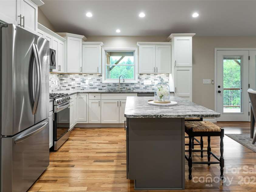 181 Flint Morgan Road, Mars Hill, NC 28754.  MLS# CAR4288459, YatesRealty ID 30594. Beautiful kitchen with gas range, large island, and shaker cabinets