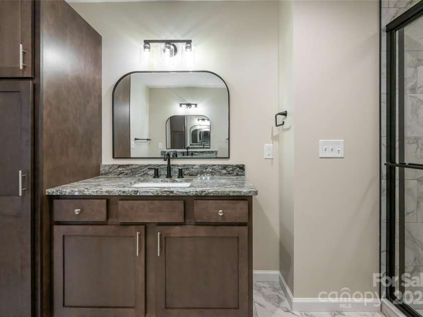 181 Flint Morgan Road, Mars Hill, NC 28754.  MLS# CAR4288459, YatesRealty ID 30594. Primary Bath features double vanities and walk-in tile shower